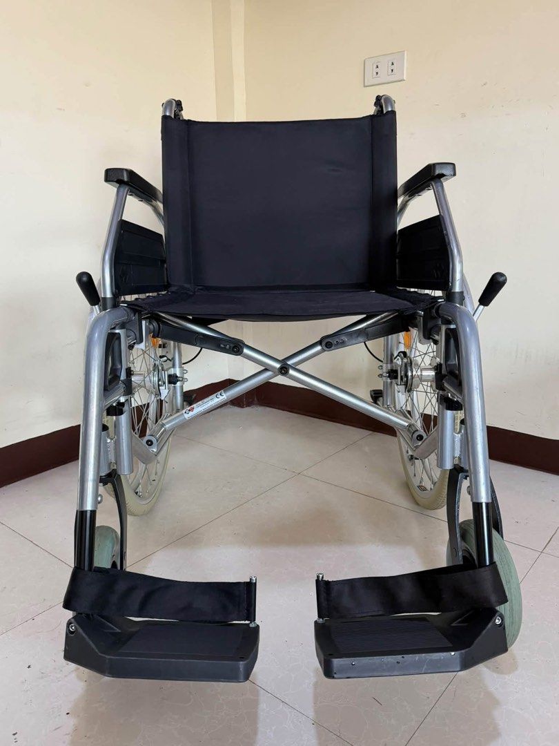 Bischoff & Bischoff Folding Wheelchair Black Silver (Category: Wheelchairs) located in Manila. Submitted by calmdolphin.87b0e4 (Listing ID 1470957146, Image 2). Description: - Brand: Bischoff & Bischoff - Color: Silver frame with black fabric upholstery - Mobility: Large rear wheels with handrims and orange reflectors + smooth front caster wheels - Comfort & Safety: Adjustable footrests with heel straps and push handles for caregivers - Convenien