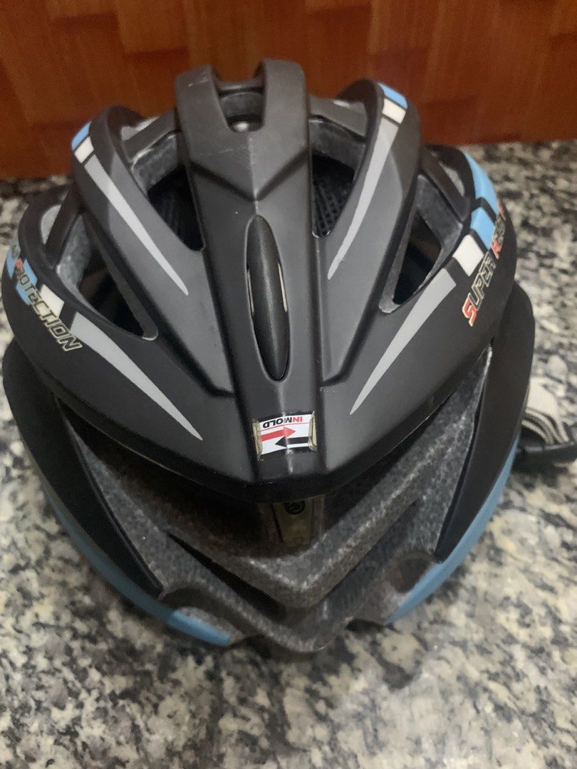 Black and blue cycling helmet with adjustable straps (Category: Bicycles) located in Malabon City. Submitted by ena.gregorio (Listing ID 1471008615, Image 1). Description: - Color: Black, grey, and light blue - Design: Aerodynamic with multiple ventilation slots to keep you cool - Comfort & Fit: Adjustable light grey straps and internal mesh lining for a secure fit - Build: Durable in-mold construction - Usage: Ideal for bike commutes and weekend
