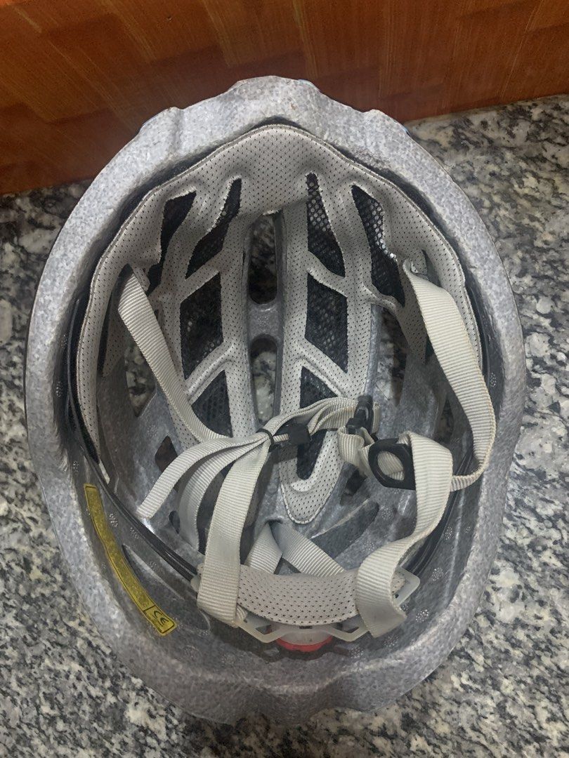 Black and blue cycling helmet with adjustable straps (Category: Bicycles) located in Malabon City. Submitted by ena.gregorio (Listing ID 1471008615, Image 3). Description: - Color: Black, grey, and light blue - Design: Aerodynamic with multiple ventilation slots to keep you cool - Comfort & Fit: Adjustable light grey straps and internal mesh lining for a secure fit - Build: Durable in-mold construction - Usage: Ideal for bike commutes and weekend