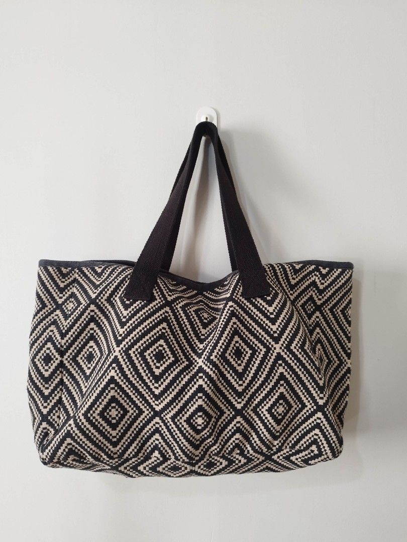 Black and White Geometric Pattern Tote Bag (Category: Tote Bags) located in Mabalacat. Submitted by gracia.atbp (Listing ID 1471007362, Image 1). Description: - Style: Black and white woven tote bag with a bold diamond geometric pattern - Straps: Thick, durable black canvas shoulder straps - Interior: Open top design with a roomy interior for all your essentials - Condition: Clean inside and out, well-maintained but with slight discoloration in b