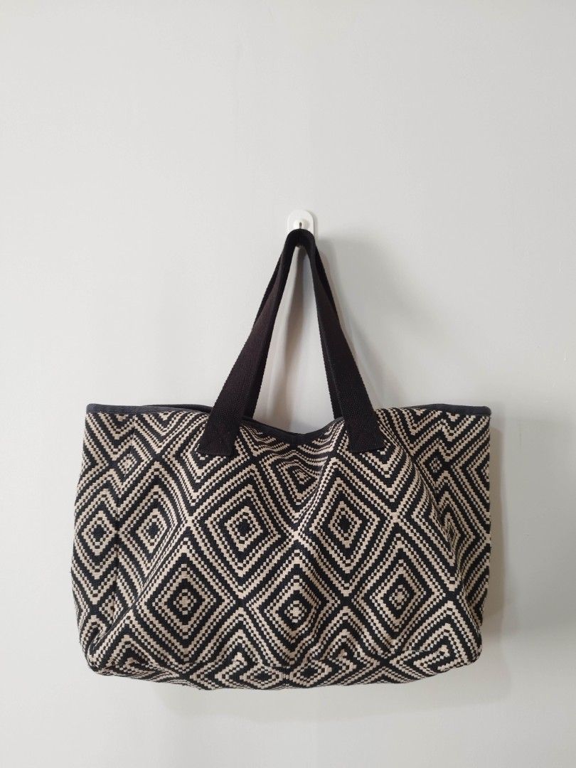 Black and White Geometric Pattern Tote Bag (Category: Tote Bags) located in Mabalacat. Submitted by gracia.atbp (Listing ID 1471007362, Image 3). Description: - Style: Black and white woven tote bag with a bold diamond geometric pattern - Straps: Thick, durable black canvas shoulder straps - Interior: Open top design with a roomy interior for all your essentials - Condition: Clean inside and out, well-maintained but with slight discoloration in b