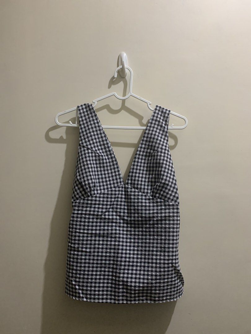 Black and White Gingham V-Neck Tank Top (Category: Sleeveless) located in Manila. Submitted by gillianau68710 (Listing ID 1471024317, Image 1). Description: - Classic black and white gingham pattern - V-neckline with comfortable thick straps - Adorable ruffled back strap details - Smocked elastic back panel for extra stretch and fit - Relaxed and breezy fit for warm weather - Perfect to pair with high-waisted shorts or skirts Custom made ✨.