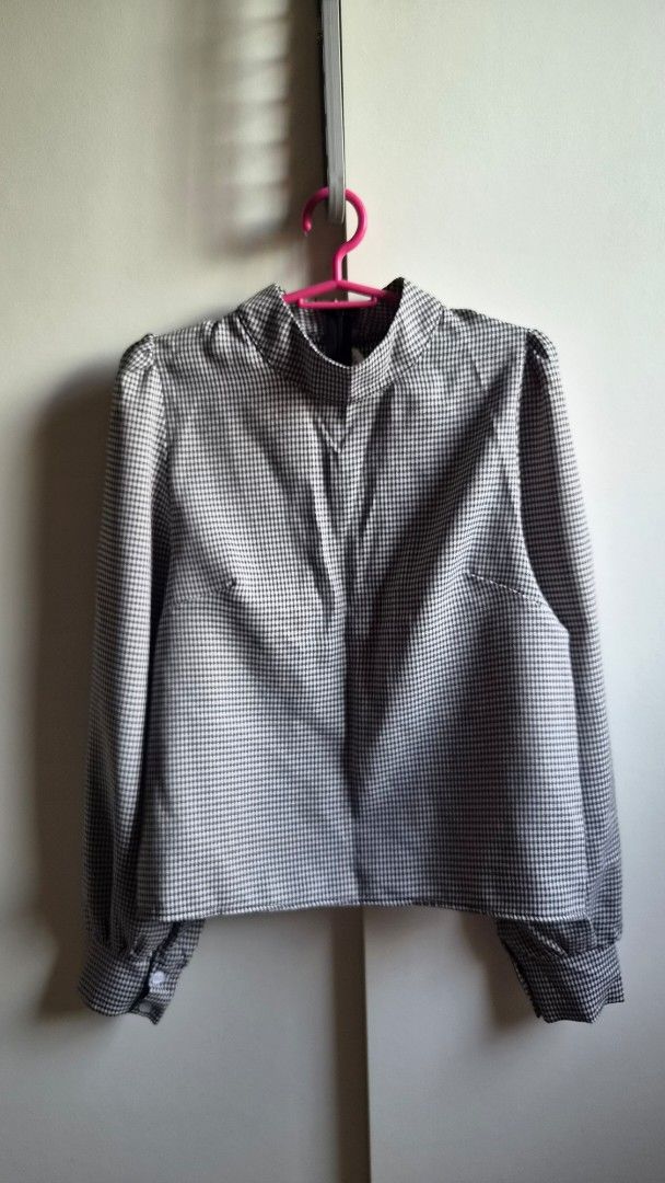 Black and white long sleeve blouse (Category: Longsleeves) located in Manila. Submitted by drc.tpwk77 (Listing ID 1470973280, Image 1). Description: - Classic black and white houndstooth pattern - Tailored fit with clean stitching and neat structure - High collar neckline and long sleeves with button cuffs - Versatile piece, pairs easily with both trousers and skirts - Perfect for workwear or smart-casual days.