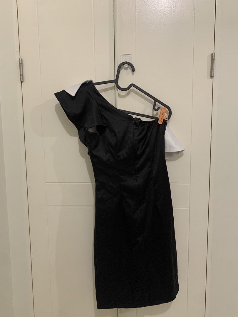 Black and White One-Shoulder Ruffle Dress (Category: Dresses) located in Pasig City. Submitted by lovedbyri (Listing ID 1471000111, Image 3). Description: - CRUELLA inspired - Style: Black and white one-shoulder bodycon dress - Design: Bold ruffle overlay along the neckline, back zipper closure - Fit: Fitted silhouette that hugs your curves - Condition: Pre-loved, with light brownish stains visible on the white ruffle fabric (kindly check the sec