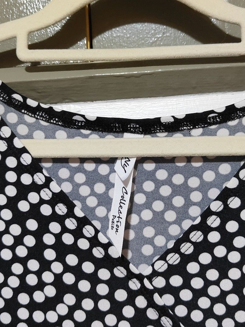 Black and White Polka Dot Midi Dress (Category: Dresses) located in Quezon City. Submitted by thestargazerspica (Listing ID 1471039947, Image 2). Description: -Can fit upto XL Style: Black midi dress with white polka dot pattern - Design: V-neck wrap top, 3/4 sleeves, fitted waist, and flared skirt - Condition: Brand new with original store tag attached - Material: Lightweight, comfortable fabric - Occasion: Ideal for daily wear and casual outing