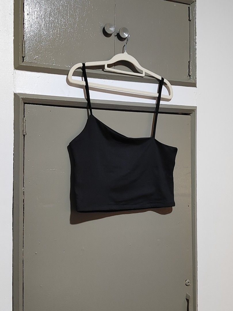 Black Asymmetric Crop Top Spaghetti Strap (Category: Sleeveless) located in Quezon City. Submitted by thestargazerspica (Listing ID 1471045497, Image 2). Description: - Color: Black - Style: One-shoulder asymmetric neckline with thin spaghetti straps - Fit: Stretchy fabric, snug and flattering fit - Versatility: Easy to pair with high-waisted jeans, skirts, or shorts - Condition: Brand new / Excellent quality.