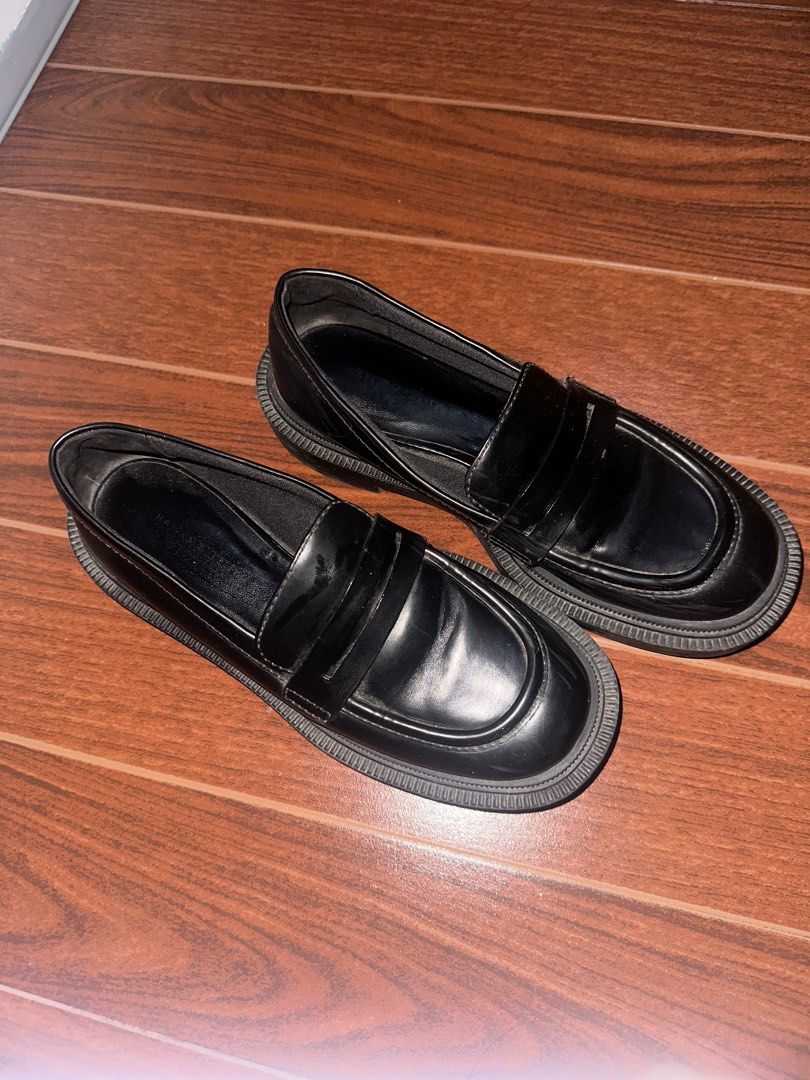 Black Chunky Lug Sole Penny Loafers (Category: Loafers) located in Manila. Submitted by ccamilg (Listing ID 1470977892, Image 2). Description: - Style: Chunky penny loafers with platform lug sole - Design: Slip-on, round toe, traditional front strap - Material: Solid black synthetic leather finish - Condition: Minimal wear on bottom soles and heels, clean interior linings - Perfect for: Elevating your everyday casual or edgy fits.