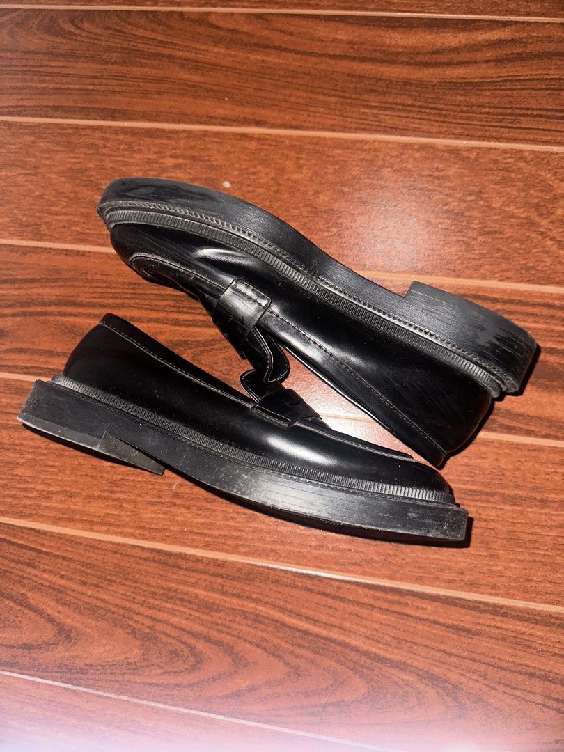 Black Chunky Lug Sole Penny Loafers (Category: Loafers) located in Manila. Submitted by ccamilg (Listing ID 1470977892, Image 3). Description: - Style: Chunky penny loafers with platform lug sole - Design: Slip-on, round toe, traditional front strap - Material: Solid black synthetic leather finish - Condition: Minimal wear on bottom soles and heels, clean interior linings - Perfect for: Elevating your everyday casual or edgy fits.
