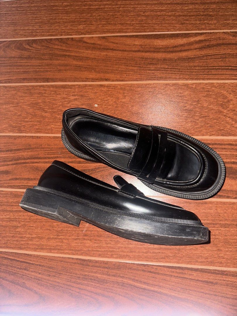 Black Chunky Lug Sole Penny Loafers (Category: Loafers) located in Manila. Submitted by ccamilg (Listing ID 1470977892, Image 1). Description: - Style: Chunky penny loafers with platform lug sole - Design: Slip-on, round toe, traditional front strap - Material: Solid black synthetic leather finish - Condition: Minimal wear on bottom soles and heels, clean interior linings - Perfect for: Elevating your everyday casual or edgy fits.