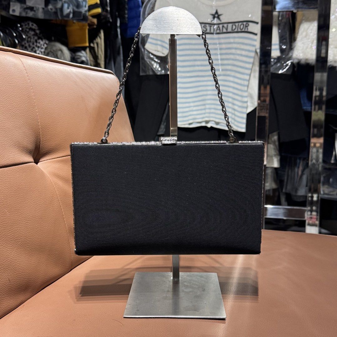 Black Evening Clutch Bag with Chain Strap and Silver Trim (Category: Clutches) located in Rizal. Submitted by houseofbell (Listing ID 1471100549, Image 1). Description: Black fabric evening clutch. Silver metallic frame with crystal-like embellishments along the edges and clasp closure. Thin chain strap attached. Interior features accordion sides, slip pocket, and lined fabric. Clean condition overall. Good size for cards, keys, and phone during 