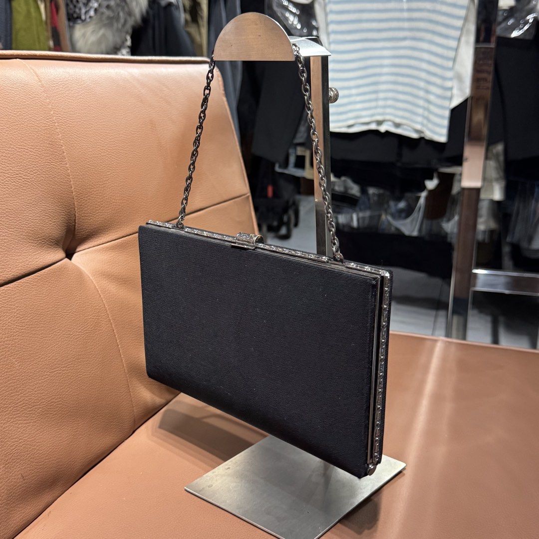 Black Evening Clutch Bag with Chain Strap and Silver Trim (Category: Clutches) located in Rizal. Submitted by houseofbell (Listing ID 1471100549, Image 3). Description: Black fabric evening clutch. Silver metallic frame with crystal-like embellishments along the edges and clasp closure. Thin chain strap attached. Interior features accordion sides, slip pocket, and lined fabric. Clean condition overall. Good size for cards, keys, and phone during 