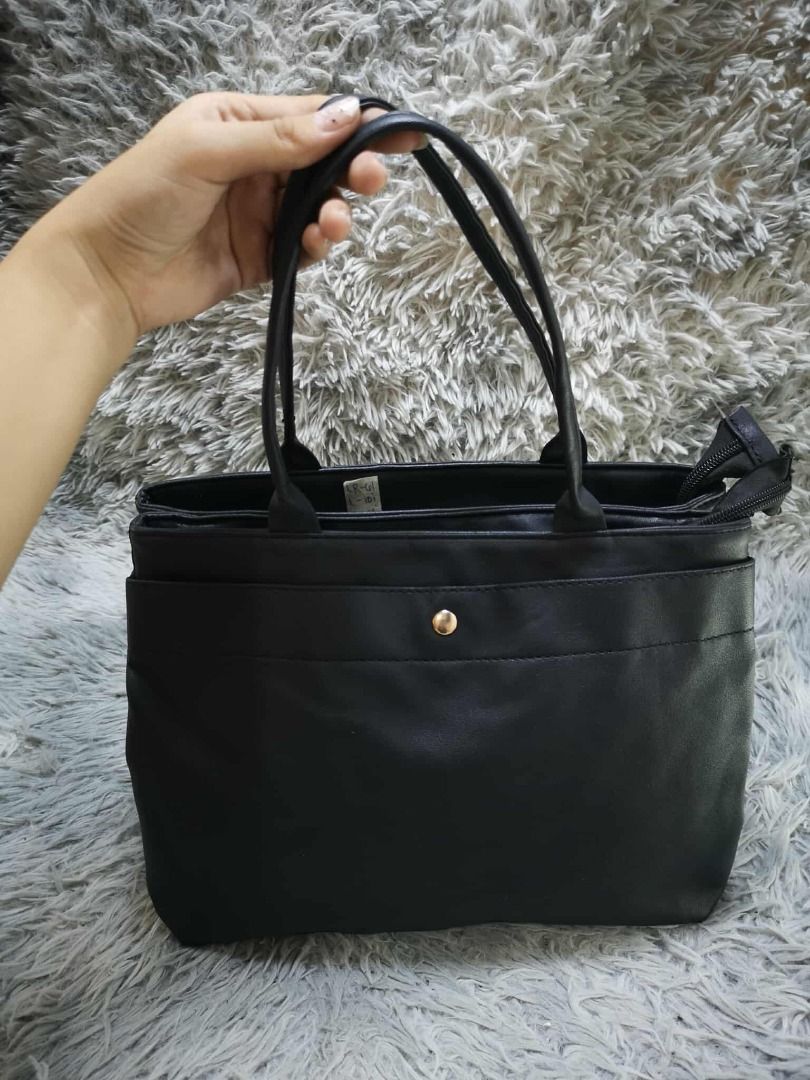 Black Faux Leather Multi Compartment Tote Shoulder Bag (Category: Shoulder Bags) located in Santa Cruz. Submitted by jmy_surplus.2 (Listing ID 1471011578, Image 1). Description: Size: L= 10i // W= 13i Color: Black Type/Kind: Tote Bag / Shoulder Bag / Handbag / Office Bag Material: Outer: Faux Leather / PU Leather (estimated) Lining: Polyester Fabric (estimated) Handles: Faux Leather Hardware: Gold-Tone Metal Closure: Top Zipper Style: Classic Min