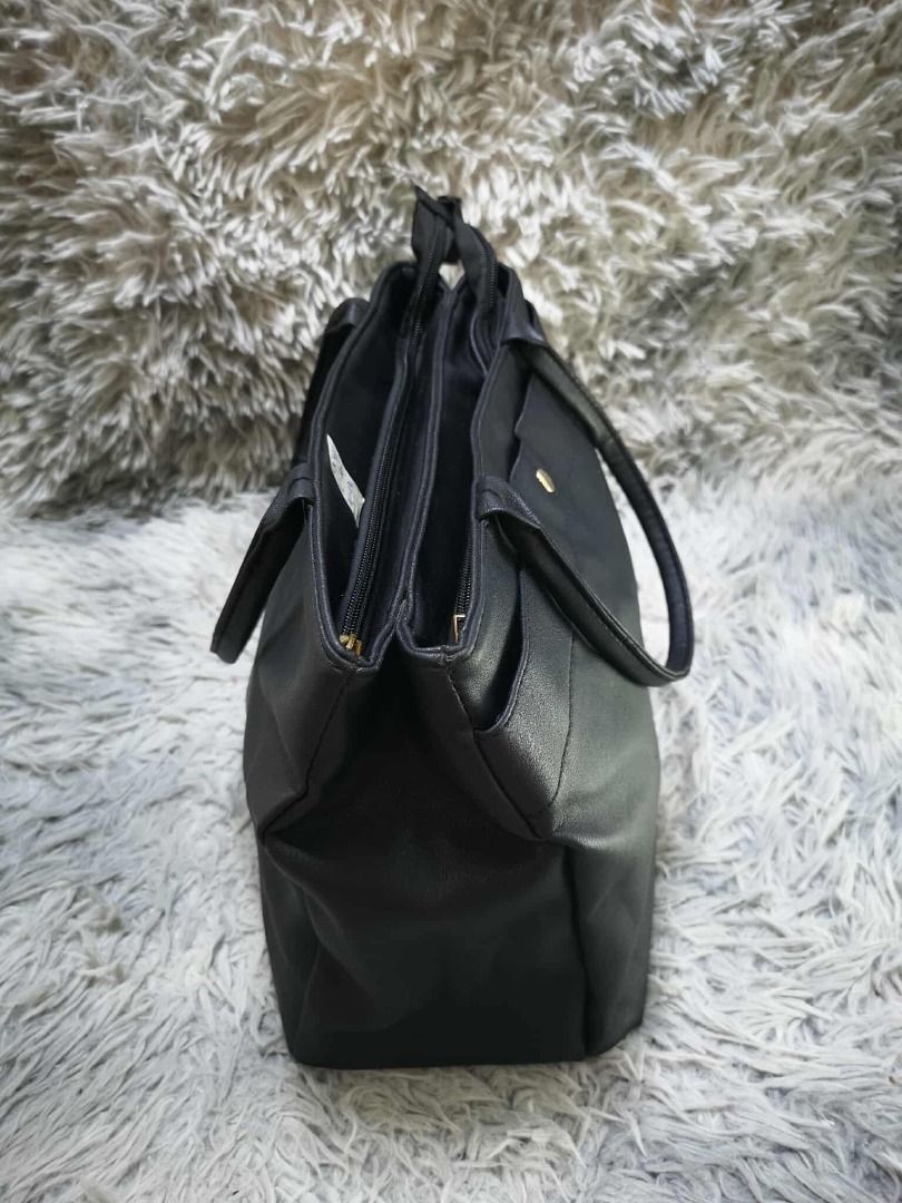 Black Faux Leather Multi Compartment Tote Shoulder Bag (Category: Shoulder Bags) located in Santa Cruz. Submitted by jmy_surplus.2 (Listing ID 1471011578, Image 3). Description: Size: L= 10i // W= 13i Color: Black Type/Kind: Tote Bag / Shoulder Bag / Handbag / Office Bag Material: Outer: Faux Leather / PU Leather (estimated) Lining: Polyester Fabric (estimated) Handles: Faux Leather Hardware: Gold-Tone Metal Closure: Top Zipper Style: Classic Min