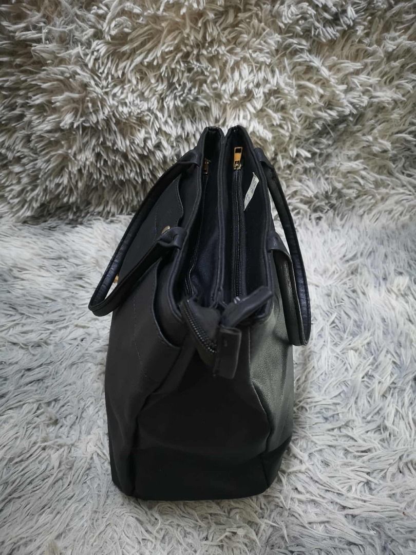Black Faux Leather Multi Compartment Tote Shoulder Bag (Category: Shoulder Bags) located in Santa Cruz. Submitted by jmy_surplus.2 (Listing ID 1471011578, Image 2). Description: Size: L= 10i // W= 13i Color: Black Type/Kind: Tote Bag / Shoulder Bag / Handbag / Office Bag Material: Outer: Faux Leather / PU Leather (estimated) Lining: Polyester Fabric (estimated) Handles: Faux Leather Hardware: Gold-Tone Metal Closure: Top Zipper Style: Classic Min