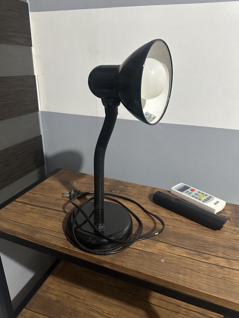Black Flexible Gooseneck Desk Lamp E27 40W Max (Category: Lighting) located in Quezon City. Submitted by _samanthajyc (Listing ID 1471067225, Image 1). Description: - Color: Black - Features: Flexible gooseneck arm and heavy round base - Bulb: Includes E27 bulb (takes up to 40W max) - Condition: Works fine when plugged in - Flaw: Cord insulation near the base has a split revealing the blue wire - Best for: DIY fix, spare parts, or garage use.