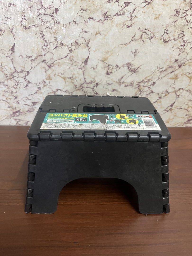 Black Folding Step Stool Compact Step Stool 50kg Capacity (Category: Ladders & Steps) located in Manila. Submitted by kayerrr.gem (Listing ID 1471049103, Image 2). Description: Black plastic folding step stool. Holds up to 50kg. Folds flat completely, easy to stash away in tight gaps. Built-in handle on top makes carrying simple. Great for reaching high shelves or for kids to use around the house..
