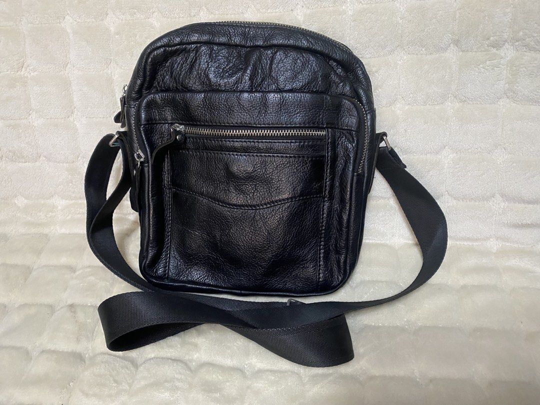 Black Leather Crossbody Bag with Multiple Pockets (Category: Sling Bags) located in Baguio. Submitted by SweetRepeat (Listing ID 1470936753, Image 1). Description: - Material: genuine leather - Strap: Adjustable webbing strap - Hardware: Sturdy silver-tone zippers - Pockets: Front zipped pocket, extra slip pocket, and inner side pockets - Compartment: Spacious main compartment - Usage: Ideal size for daily essentials like phone, keys, and wallet.