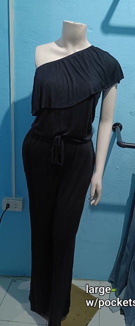 Black One-Shoulder Jumpsuit Size L with Pockets (Category: Jumpsuits) located in Quezon City. Submitted by davidclothing (Listing ID 1470954444, Image 1). Description: - Color: Sleek black - Style: One-shoulder jumpsuit with long pants - Details: Ruffle overlay neckline, drawstring waist, and deep pockets - Size: Large - Fabric: Soft and stretchy for all-day comfort.
