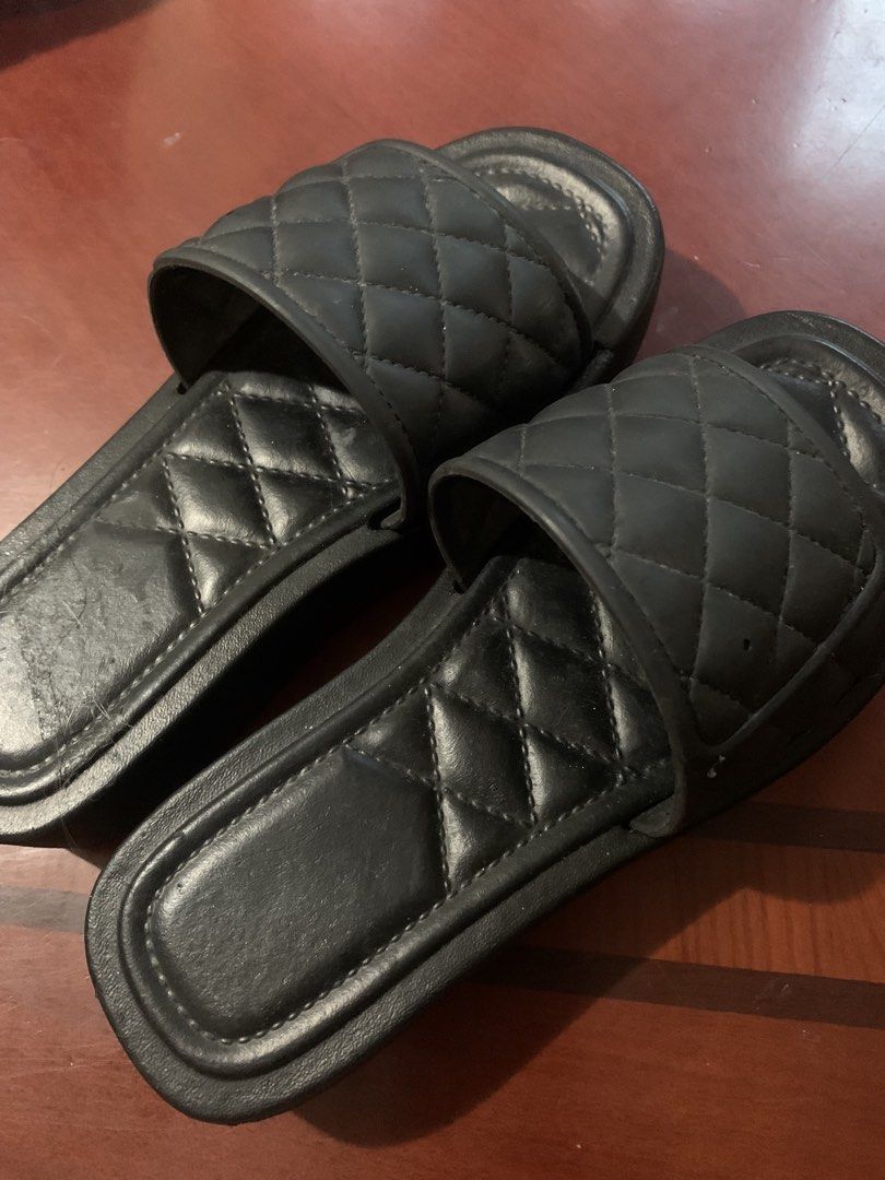 Black quilted slip-on sandals flats slides (Category: Flats & Sandals) located in Paranaque City. Submitted by declutterby4angels (Listing ID 1471014501, Image 1). Description: - Color: Black - Style: Slip-on slide sandals - Design: Padded upper strap with diamond stitch pattern - Sole: Solid and thick for durability - Condition: Minor wear and dust on the footbed - Best for: House wear or casual errands -Size :33.