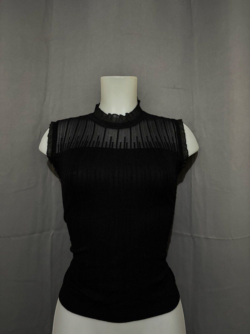 Black ribbed boat neck knit top (Category: Sleeveless) located in Pasig City. Submitted by jangrepuya23 (Listing ID 1471096683, Image 2). Description: Black ribbed knit top with a boat neckline and half sleeves. Fitted silhouette. Stretchy fabric. Great basic piece for layering or wearing on its own..