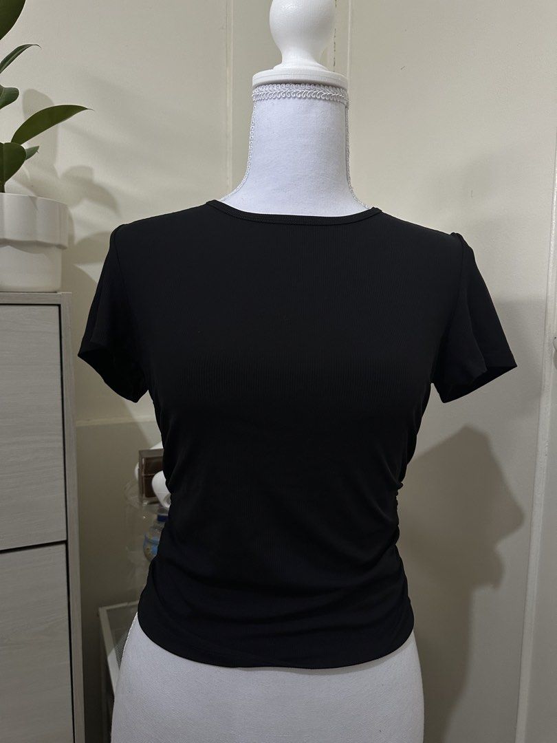 Black ribbed short sleeve t-shirt (Category: Shirts) located in Antipolo. Submitted by wxyz9876 (Listing ID 1470963496, Image 2). Description: - Color: Classic Black - Fabric: Soft, stretchy ribbed material - Fit: Slim fit, comfortably fits small to medium frames - Design: Crew neckline, clean back, and trendy ruched sides - Styling: Great basic piece to pair with high-waisted jeans or skirts.