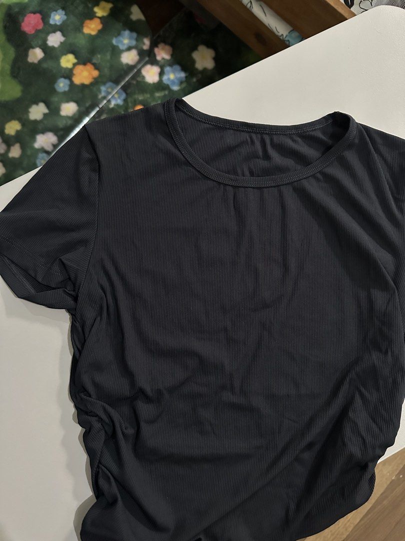 Black ribbed short sleeve t-shirt (Category: Shirts) located in Antipolo. Submitted by wxyz9876 (Listing ID 1470963496, Image 1). Description: - Color: Classic Black - Fabric: Soft, stretchy ribbed material - Fit: Slim fit, comfortably fits small to medium frames - Design: Crew neckline, clean back, and trendy ruched sides - Styling: Great basic piece to pair with high-waisted jeans or skirts.