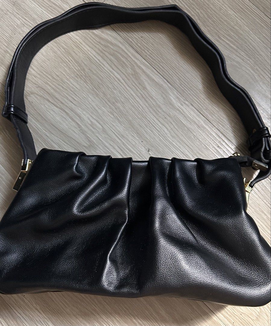 Black Ruched Shoulder Bag (Category: Shoulder Bags) located in Manila. Submitted by coffeeislyf (Listing ID 1470985835, Image 2). Description: - Color: Classic Black - Material: Textured faux leather - Design: Trendy gathered, ruched style with metallic hardware accents - Strap: Comfortable shoulder strap included - Condition: Clean interior and exterior, with minor creases from storage only.
