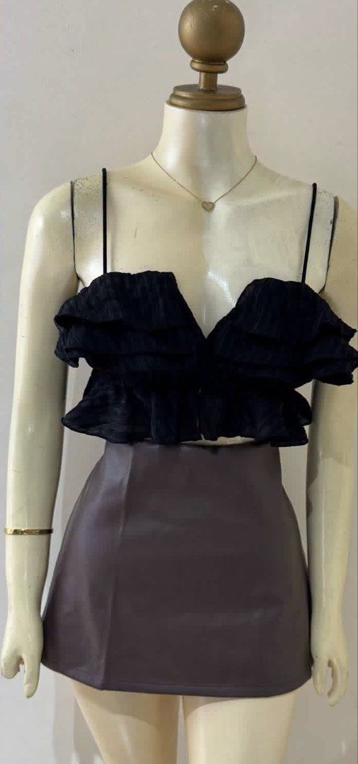 Black ruffled crop top with spaghetti straps (Category: Sleeveless) located in Batangas. Submitted by chezkagrace_.428 (Listing ID 1471073036, Image 2). Description: - Color: Black - Style: Crop top with multi-layered ruffles and deep V-cut neckline - Details: Thin spaghetti straps and all-over textured crinkled fabric - Versatility: Great for nights out or casual days - Pairing: Easily matches with skirts, high-waisted pants, or shorts.