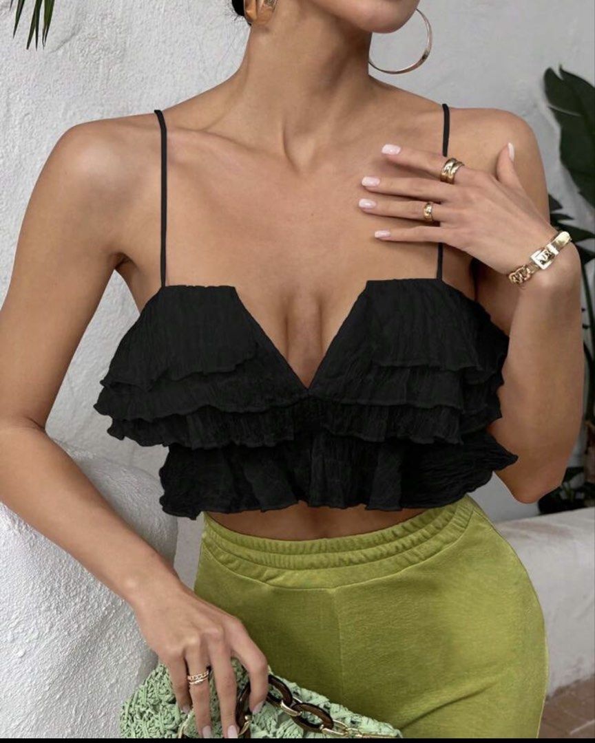 Black ruffled crop top with spaghetti straps (Category: Sleeveless) located in Batangas. Submitted by chezkagrace_.428 (Listing ID 1471073036, Image 3). Description: - Color: Black - Style: Crop top with multi-layered ruffles and deep V-cut neckline - Details: Thin spaghetti straps and all-over textured crinkled fabric - Versatility: Great for nights out or casual days - Pairing: Easily matches with skirts, high-waisted pants, or shorts.