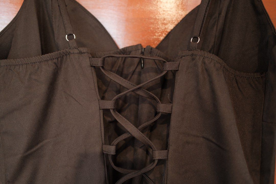 Black Spaghetti Strap Midi Dress with Lace-Up Back (Category: Dresses) located in Makati City. Submitted by nomoreclutterph (Listing ID 1471048700, Image 3). Description: - Color: Classic Black - Style: Midi dress with thin spaghetti straps, fitted bodice, and flared skirt - Details: Adjustable criss-cross ribbon lacing at the back with a back zipper closure - Material: Smooth, structured fabric - Versatility: Perfect for dinner dates, parties, o