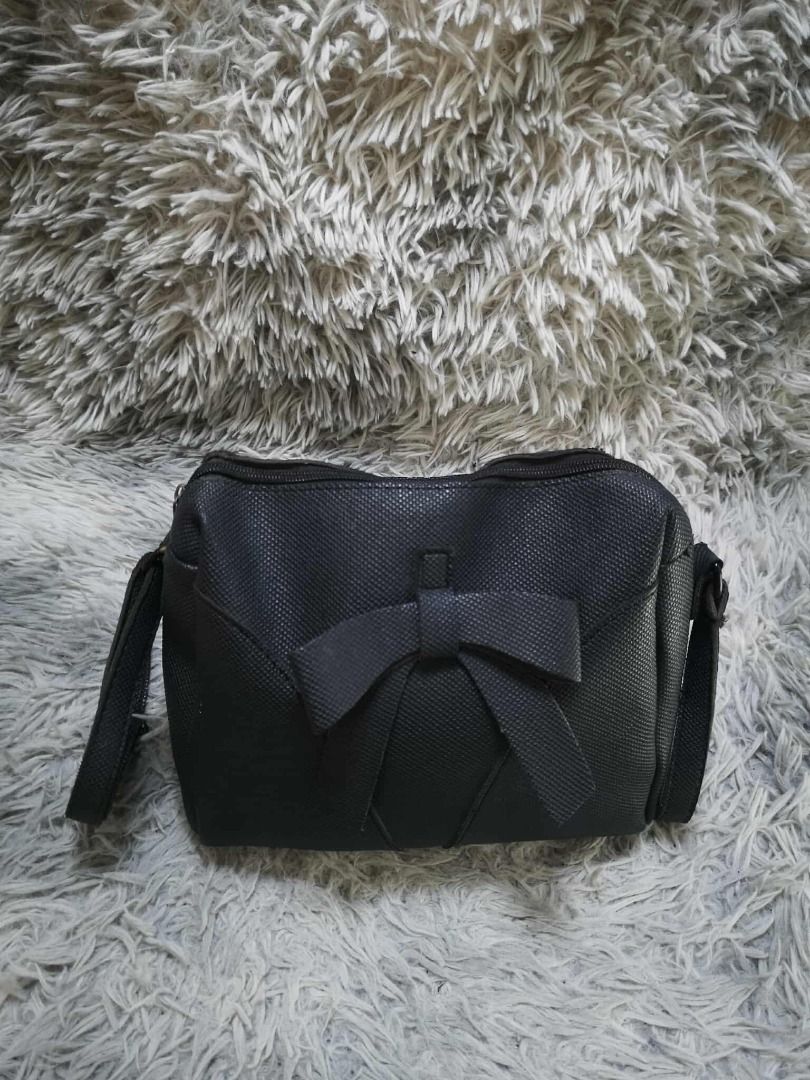 Black Textured Bow Detail Shoulder Bag (Category: Cross-body Bags) located in Santa Cruz. Submitted by jmy_surplus.2 (Listing ID 1471021495, Image 3). Description: Color: Black Type/Kind: Shoulder Bag / Crossbody Bag / Bow Bag Material: Body: Textured Faux Leather / Synthetic Leather (unverified) Strap: Textured Synthetic Material Lining: Black Fabric Hardware: Silver-Tone Metal Style: Feminine Girly Coquette Cute Casual Chic Minimalist Korean-In