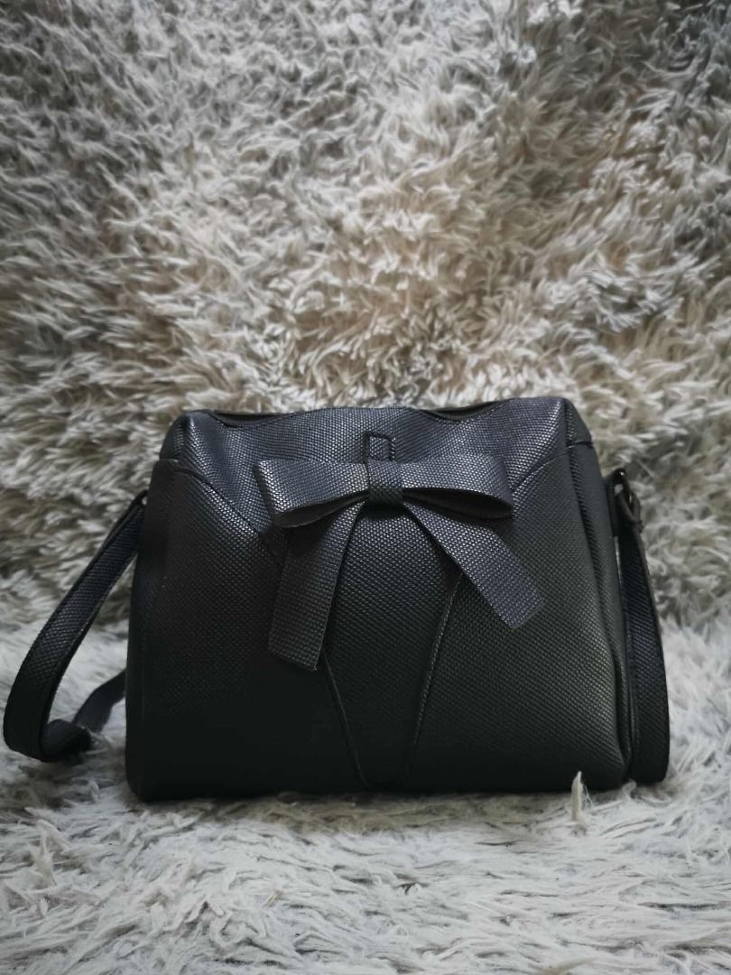 Black Textured Bow Detail Shoulder Bag (Category: Cross-body Bags) located in Santa Cruz. Submitted by jmy_surplus.2 (Listing ID 1471021495, Image 1). Description: Color: Black Type/Kind: Shoulder Bag / Crossbody Bag / Bow Bag Material: Body: Textured Faux Leather / Synthetic Leather (unverified) Strap: Textured Synthetic Material Lining: Black Fabric Hardware: Silver-Tone Metal Style: Feminine Girly Coquette Cute Casual Chic Minimalist Korean-In