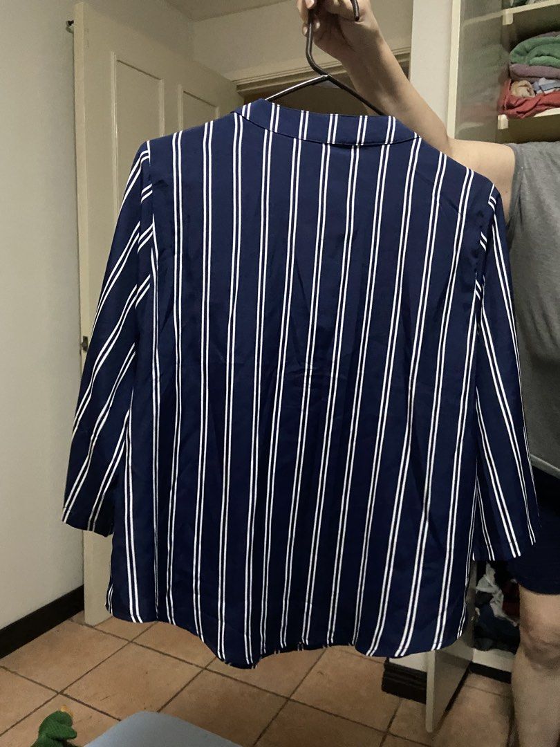 Blue and White Striped V-Neck Blouse (Category: Blouses) located in Manila. Submitted by gigstlauron (Listing ID 1471092337, Image 2). Description: - Color & Pattern: Navy blue with vertical white stripes - Style: V-neckline with folded collar, long sleeves with button tabs - Fit: Relaxed and lightweight, easy to pair with jeans or slacks - Occasion: Perfect for work or casual outings - Condition: Clean, well-kept, and ready to wear.