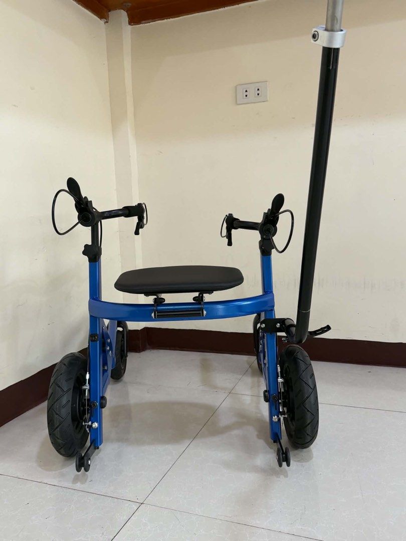 Blue Four-Wheel Mobility Walker with Seat and Push Handle (Category: Wheelchairs) located in Manila. Submitted by calmdolphin.87b0e4 (Listing ID 1470959860, Image 1). Description: - Color: Blue with thick black tires - Sturdy frame with a built-in seat for resting - Dual handbrakes for safety and control - Long adjustable push bar on the back - Comfortable rubber grips on handles - Smooth-rolling wheels suitable for indoor floors and outdoor path
