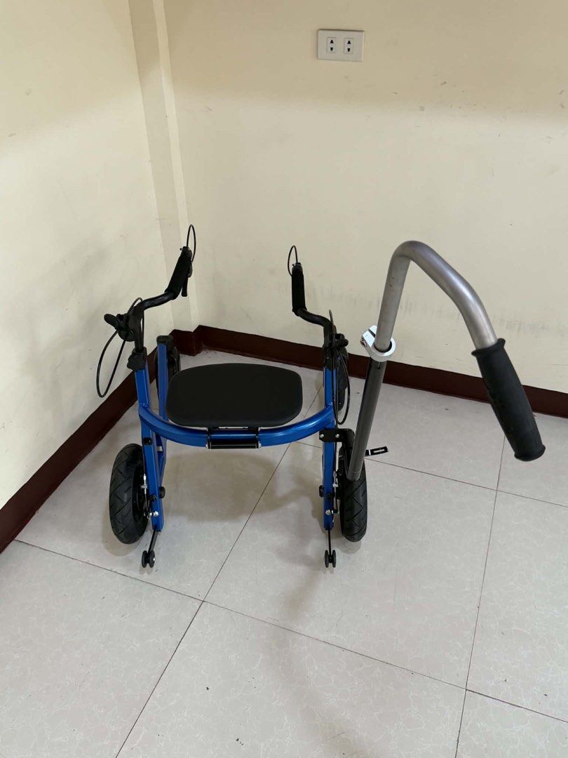 Blue Four-Wheel Mobility Walker with Seat and Push Handle (Category: Wheelchairs) located in Manila. Submitted by calmdolphin.87b0e4 (Listing ID 1470959860, Image 2). Description: - Color: Blue with thick black tires - Sturdy frame with a built-in seat for resting - Dual handbrakes for safety and control - Long adjustable push bar on the back - Comfortable rubber grips on handles - Smooth-rolling wheels suitable for indoor floors and outdoor path