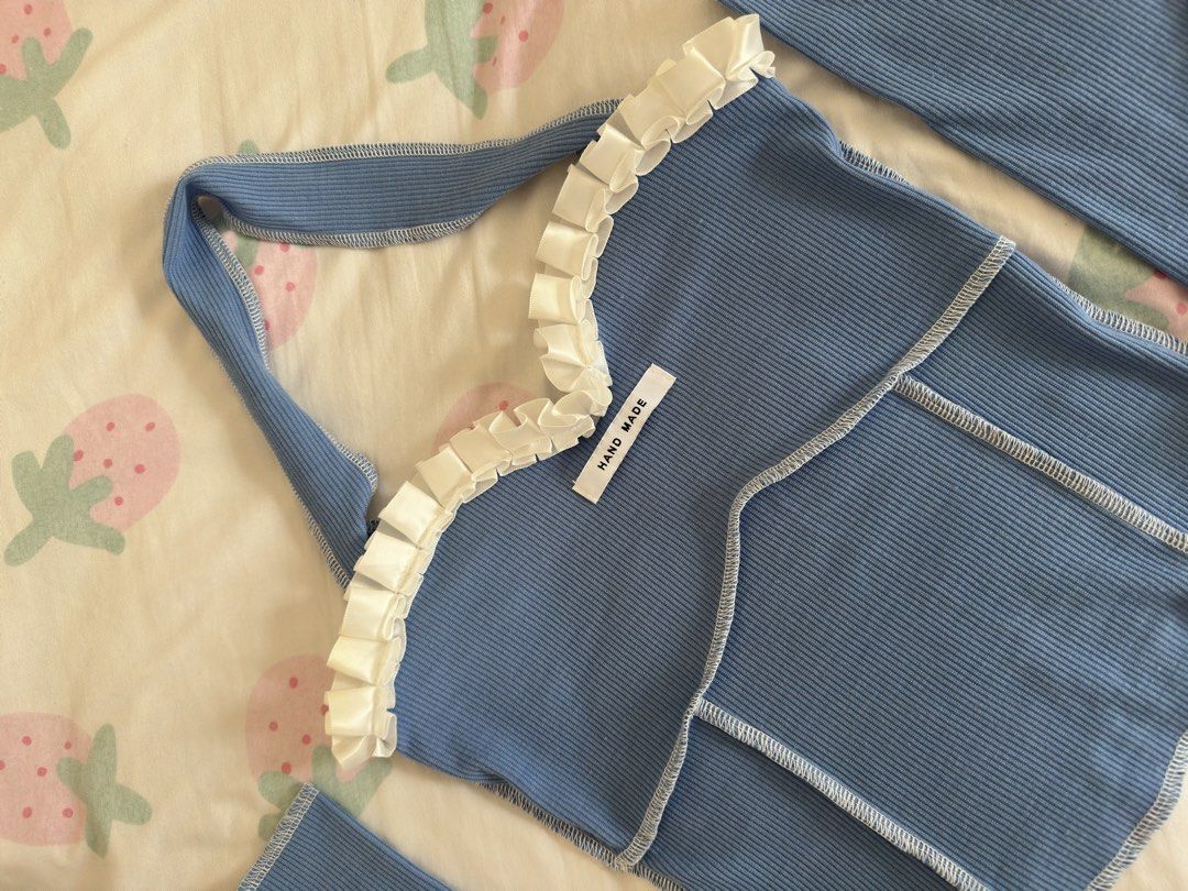 Blue Halter Crop Top With Matching Sleeves (Category: Sets or Coordinates) located in Manila. Submitted by preloved-bycath (Listing ID 1471078877, Image 2). Description: - Color: Light blue with white contrast stitching - Style: Ribbed crop top with halter neck and sweetheart neckline - Details: White ruffle trim, 'HAND MADE' chest label - Extras: Includes matching separate long sleeves with thumbholes - Condition: Brand new / Excellent quality -