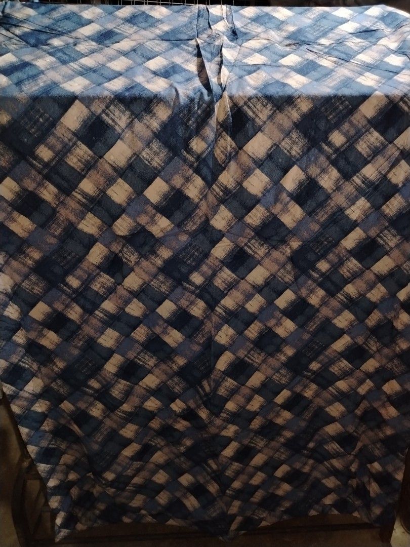 Blue Plaid Quilt with Floral Backing (Category: Bedding & Towels) located in Manila. Submitted by mimachelleukay (Listing ID 1471049870, Image 1). Description: - Blue and white plaid quilt - Reversible design with white background and gold floral pattern - Soft and cozy quilted texture - Perfect for layering on a bed or couch - Ideal winter blanket.