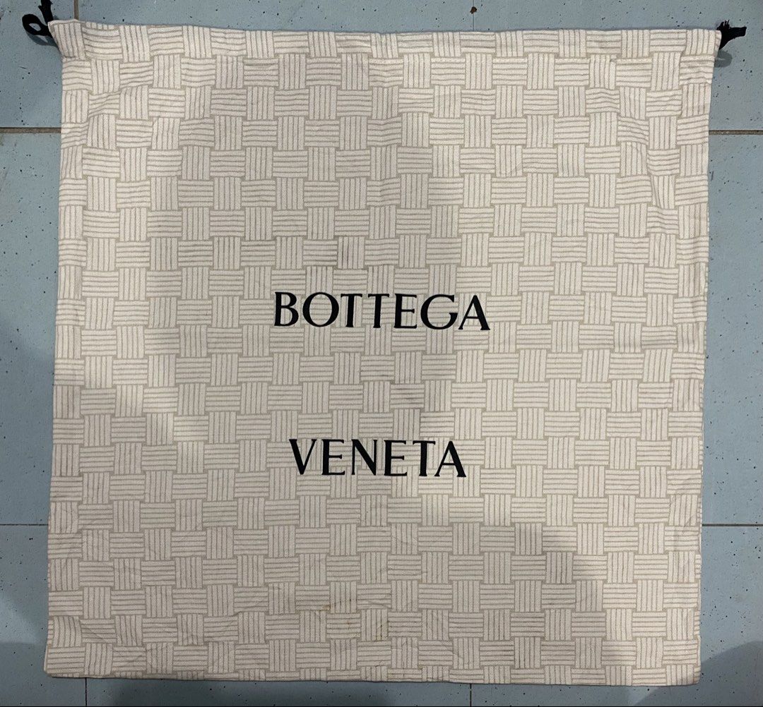 Bottega Veneta Intrecciato Pattern Dust Bag (Category: Luxury Bags & Wallets) located in Davao. Submitted by dandeshop (Listing ID 1471089274, Image 1). Description: - 100% Authentic Bottega Veneta dust bag - Elegant beige fabric with signature intrecciato weave pattern print - Features bold black Bottega Veneta logo stamped in the center - Secure dual drawstring closure with black cords - Pristine and clean fabric surface - Ideal for safely stor