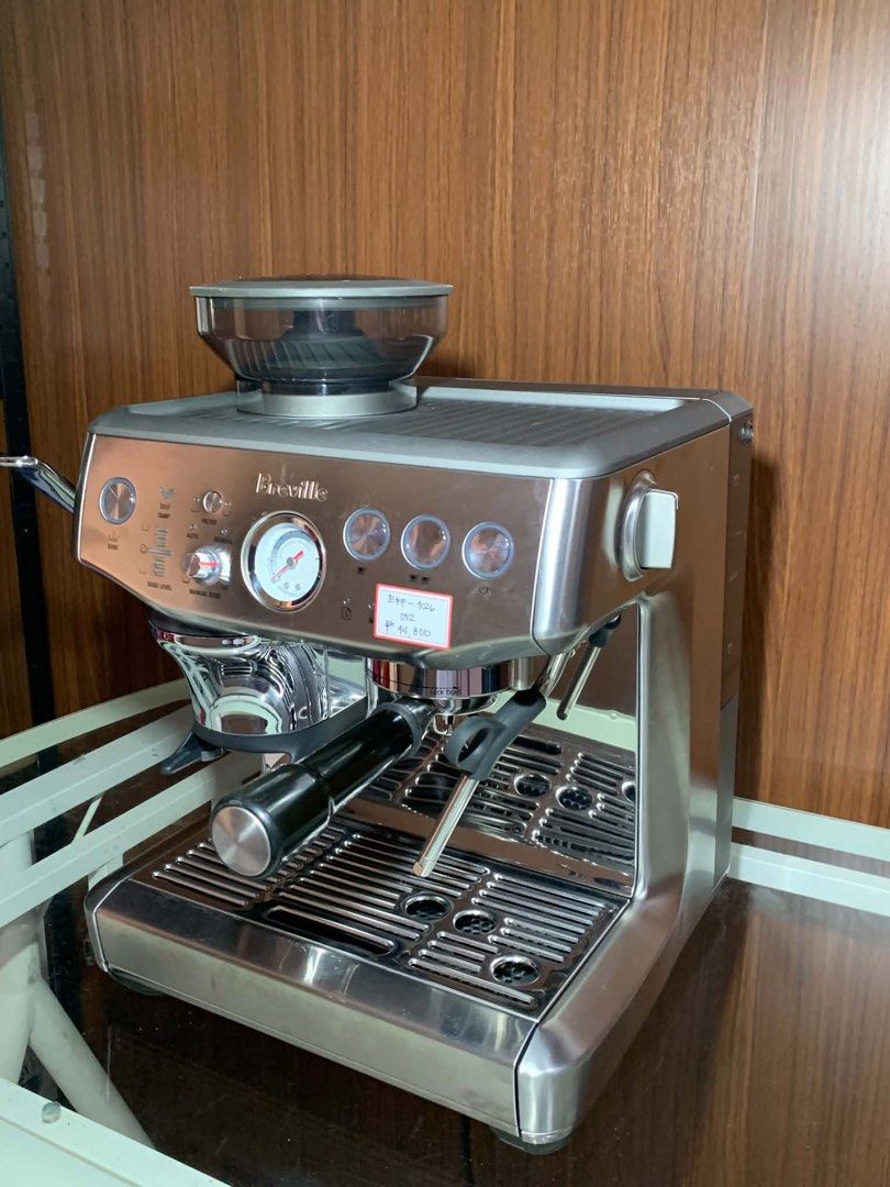 Breville Barista Express Espresso Machine (Category: Coffee Machines & Makers) located in Pulilan. Submitted by sebbii (Listing ID 1470959218, Image 2). Description: Breville espresso machine in stainless steel finish. Built-in grinder on top with bean hopper. Pressure gauge right on the front panel. Portafilter locks into the group head smoothly. Steam wand attached on the side for frothing milk. Drip tray sits securely underneath. Power button,