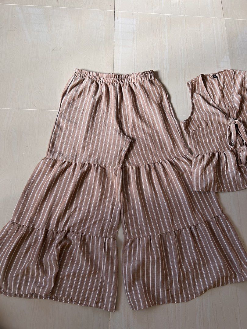 Brown Coords Pants Set- XL (Category: Sets or Coordinates) located in Caloocan City. Submitted by declutterieee (Listing ID 1471028162, Image 2). Description: - Color/Pattern: Brown and white vertical stripes - Set includes: Sleeveless top and matching pants - Top details: Double front ties and a cute ruffled hem - Pants details: Comfy elastic waistband and stylish tiered ruffled legs - Fabric: Lightweight and breathable material - Condition: Bra