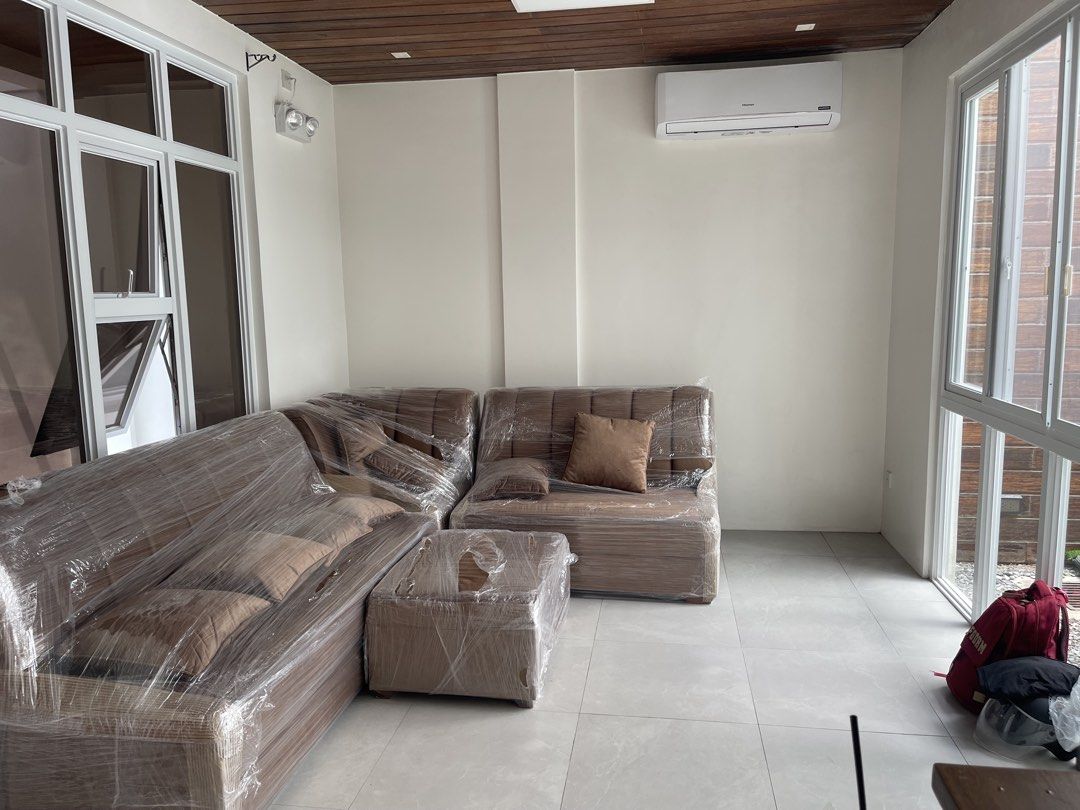Brown L-shaped sectional sofa with matching ottoman (Category: Sofas) located in Cainta. Submitted by jordddddddd (Listing ID 1471097857, Image 3). Description: - Brown L-shaped sectional sofa set - Includes matching ottoman and scatter cushions - Upholstered in soft fabric with stylish vertical channel tufting - Spacious seating for family and guests, ideal for living rooms or lounges.