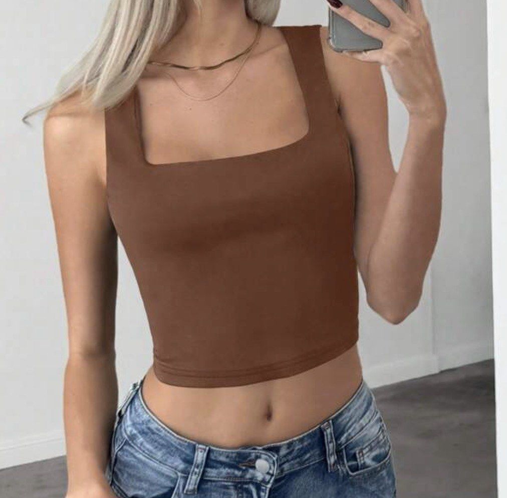 Brown Square Neck Crop Top (Category: Sleeveless) located in Manila. Submitted by coffeeislyf (Listing ID 1470989973, Image 1). Description: - Color: Brown - Style: Crop top with square neckline and thick straps - Fit: Snug, stretchy fabric - Condition: Excellent, no flaws - Styling: Great for everyday wear with high-waisted jeans or shorts.