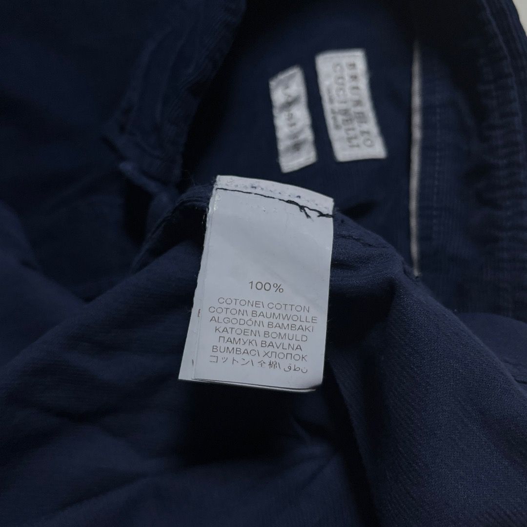 Brunello Cucinelli Dark Blue Corduroy Button-Down Shirt (Category: Tshirts & Polo Shirts ) located in Caloocan City. Submitted by achilles_grails (Listing ID 1471054652, Image 3). Description: - Brand: Brunello Cucinelli - Color: Dark blue - Material: 100% cotton with soft ribbed corduroy texture - Fit: Loose fit silhouette - Details: Button-down collar, single chest pocket, contrasting dark buttons, standard front button closure - Origin: Crafte