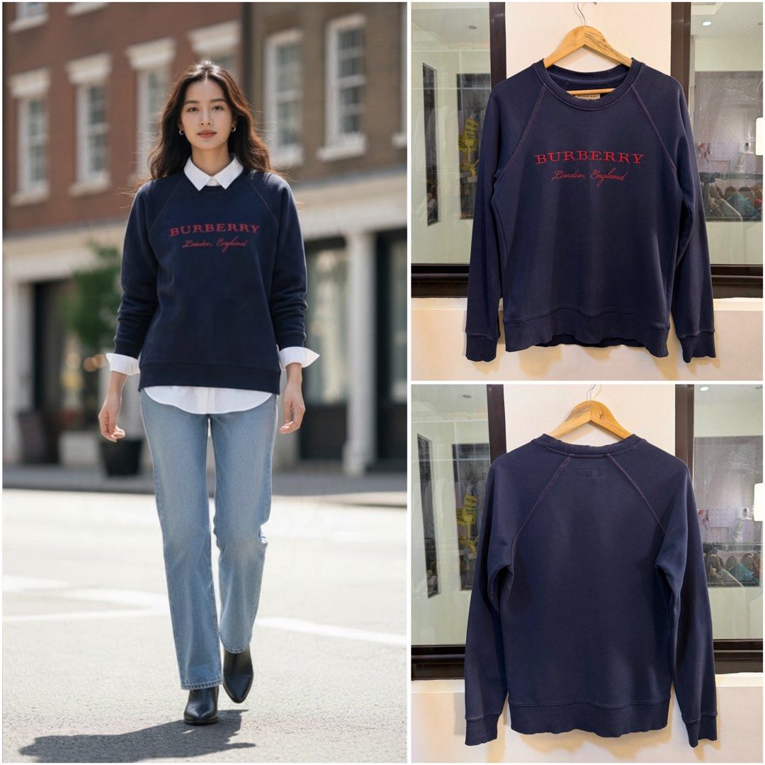 Burberry Crewneck Sweatshirt (Category: Coats, Jackets and Outerwear) located in Paranaque City. Submitted by preluxeshop_ph (Listing ID 1471014647, Image 1). Description: Brand: Burberry •Style: Raglan Crewneck Sweatshirt / Pullover •Color: Dark Navy Blue •Design Features: Embroidered red “BURBERRY London, England” script branding on the front chest, raglan sleeve construction with contrast stitching accents, classic crew neckline, and ribbed co