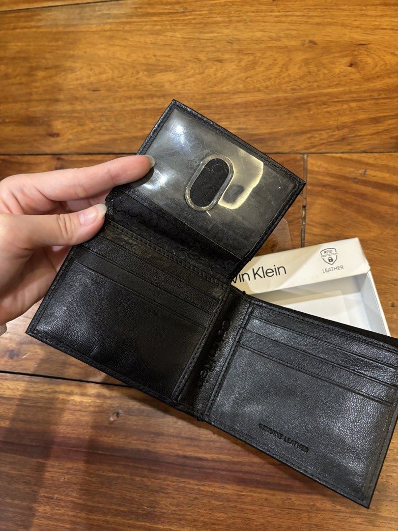Calvin Klein Black Leather RFID Protection Wallet (Category: Wallets & Card holders) located in Manila. Submitted by pepper7779 (Listing ID 1471026896, Image 3). Description: - Brand: Calvin Klein - Material: Genuine black leather - Condition: Brand new with original box and tags - Security: Built-in RFID protection - Features: Multiple card slots, cash compartment, and clear ID window flap - Design: Metal logo plate on front with CK monogram int