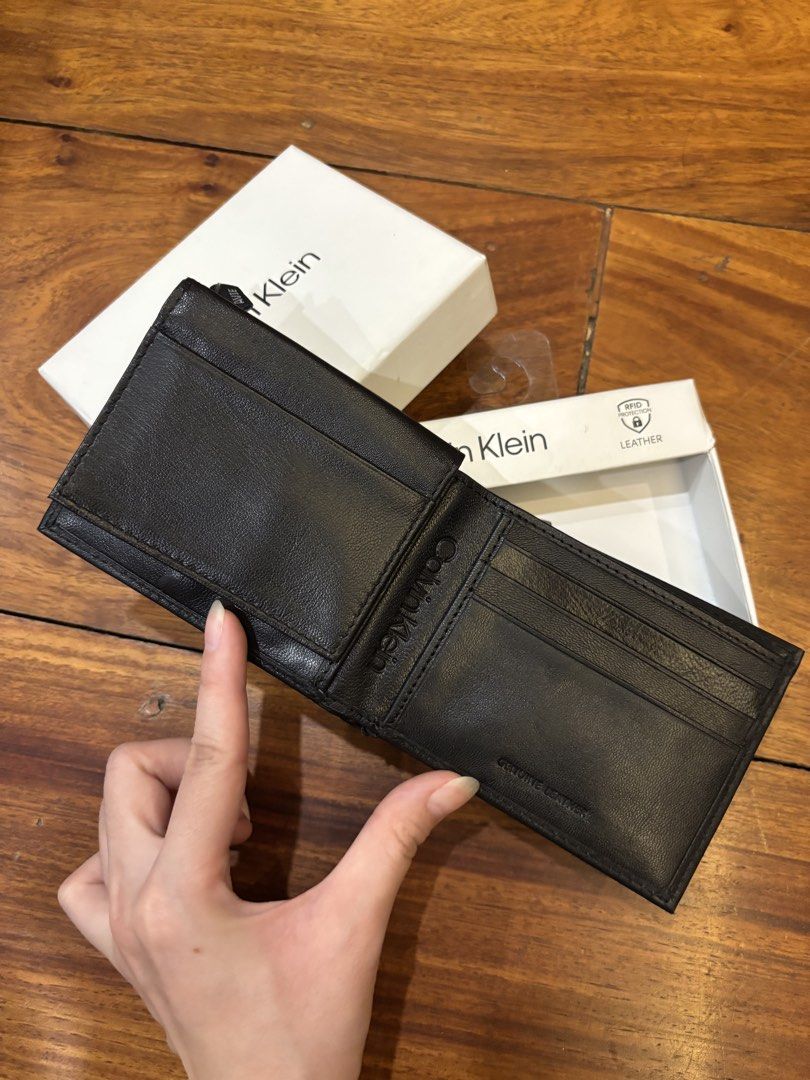 Calvin Klein Black Leather RFID Protection Wallet (Category: Wallets & Card holders) located in Manila. Submitted by pepper7779 (Listing ID 1471026896, Image 2). Description: - Brand: Calvin Klein - Material: Genuine black leather - Condition: Brand new with original box and tags - Security: Built-in RFID protection - Features: Multiple card slots, cash compartment, and clear ID window flap - Design: Metal logo plate on front with CK monogram int