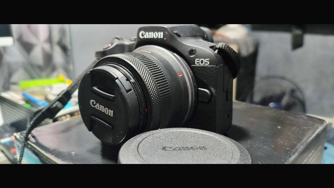 Canon EOS R100 Mirrorless Camera with RF-S 18-45mm Lens (Category: Cameras) located in Manila. Submitted by alphandomega (Listing ID 1470961187, Image 1). Description: Selling my Canon EOS R100, seldom used. Bought last year, barely used, lady-owned, well taken care of, and in excellent condition. RFS: Need funds Inclusions: - Canon EOS R100 camera body - Lens - Lens cap - Battery charger - SD card Features: - 24.1MP APS-C CMOS sensor for sharp, 