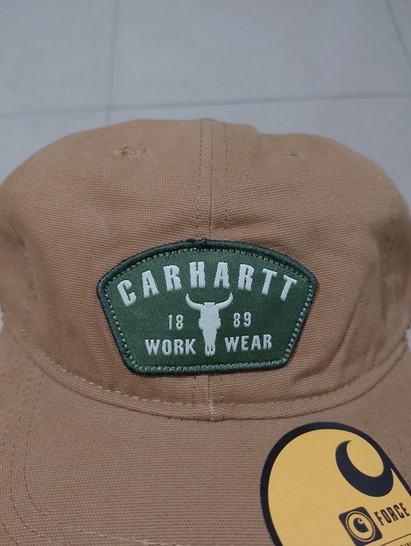 Carhartt Force Work Wear Brown Cap (Category: Caps & Hats) located in Manila. Submitted by thriftyboyzzz (Listing ID 1470998156, Image 2). Description: - Brand: Carhartt - Color: Brown with unique green bull skull patch (1889 work wear branding) - Technology: Force sweatband inside for quick-drying sweat-wicking comfort - Material: 100% Cotton - Fit: Adjustable strap back with Carhartt logo label (OSFA - One Size Fits All) - Condition: Brand new 