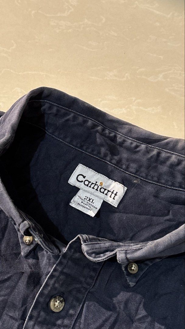Carhartt Long Sleeve Button Down Shirt 2XL (Category: Tshirts & Polo Shirts ) located in Manila. Submitted by glano (Listing ID 1471101624, Image 3). Description: - Brand: Carhartt - Item: Long Sleeve Button-Down Shirt - Color: Navy Blue - Size: 2XL - Material: 100% Cotton (Heavy fabric weight) - Features: Dual chest pockets, leather Carhartt logo patch, button cuffs, standard collar - Condition: Excellent / Ready to wear - Mode of Payment: GCash