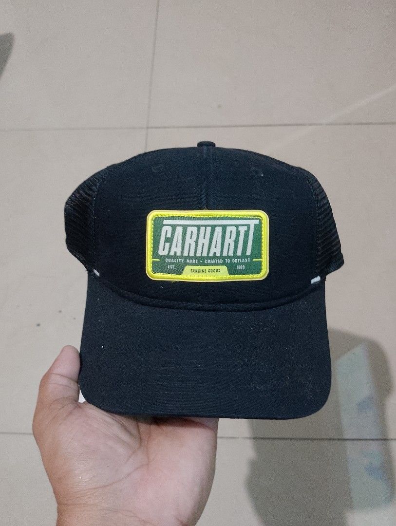 Carthoart AH0289 Black Trucker Cap (Category: Caps & Hats) located in Manila. Submitted by thriftyboyzzz (Listing ID 1470997618, Image 1). Description: - Brand: Carhartt - Color: Classic black with green and yellow logo patch - Style: Trucker hat with breathable mesh back panels - Fit: Adjustable snapback closure (Standard adult sizing) - Material: 100% cotton front panel - Condition: Excellent/New - Mode of Payment: GCash, BPI, or COD via Shopee